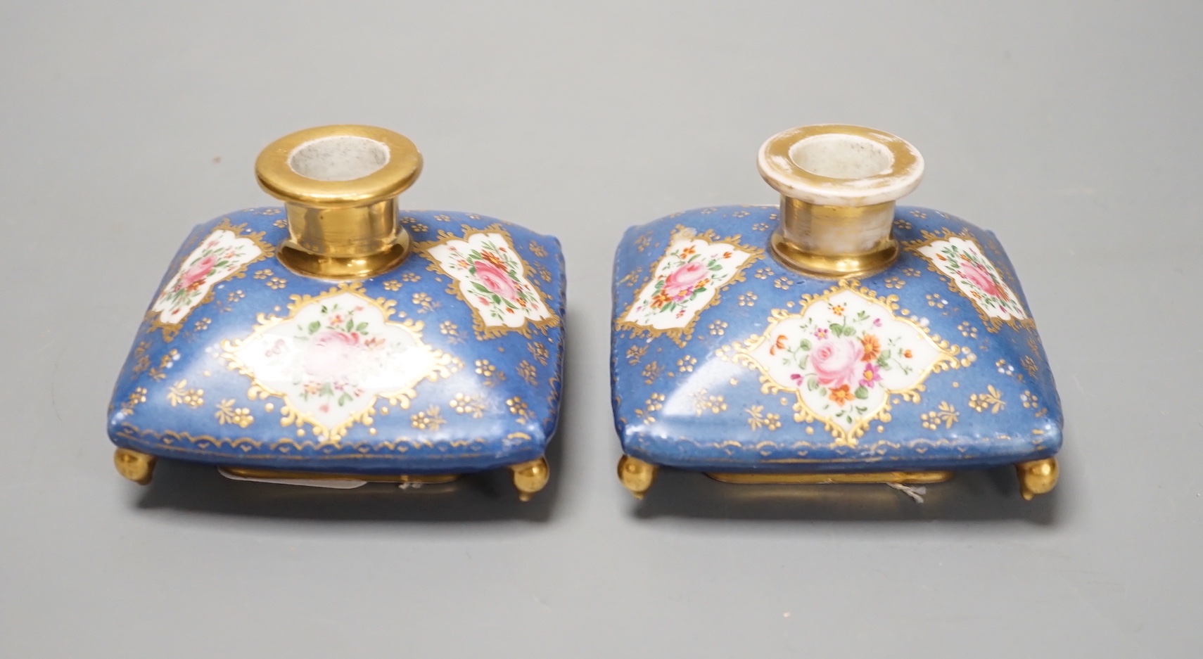 A pair of mid 19th century Paris porcelain 'cushion' shaped scent bottles decorated in Sevres style with pink roses (lacking stoppers)
